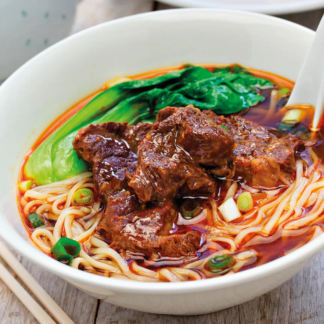 Slow-braised beef noodles in spicy broth with bok choy